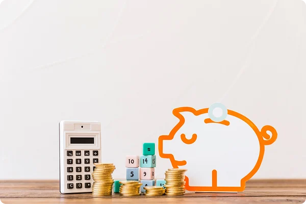 An image depicting daycare financial planning with stacked coins, calculators, and a piggy bank